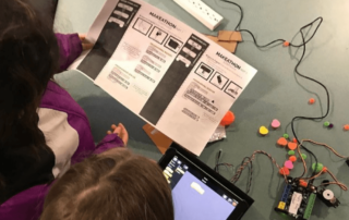 Students reading and working on robots in the library!