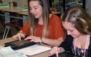 Students working with on iPads at Alki Middle School.