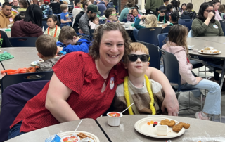 Families enjoying breakfast at a Read Across America event.